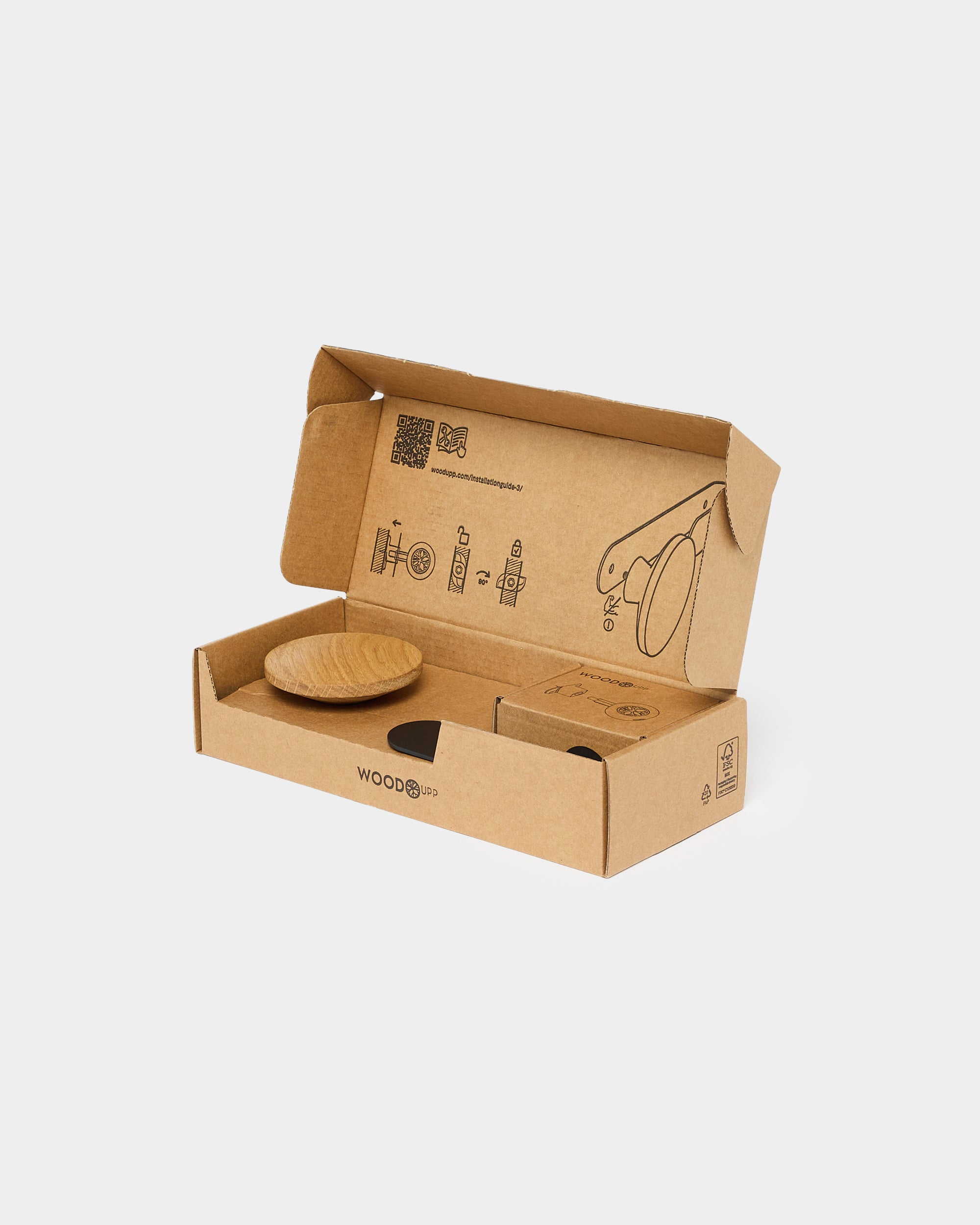 Open brown cardboard box with a round acoustic panel and assembly instructions printed on the inside of the lid.